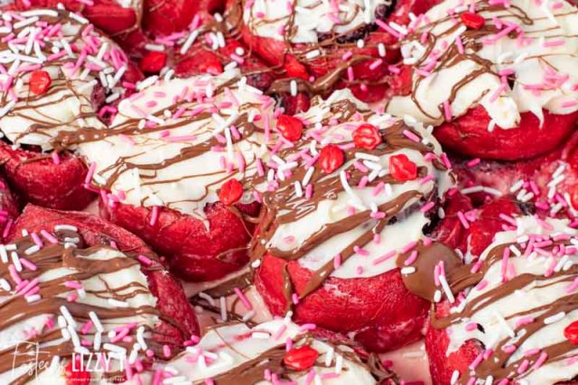 red velvet sweet rolls with chocolate drizzle
