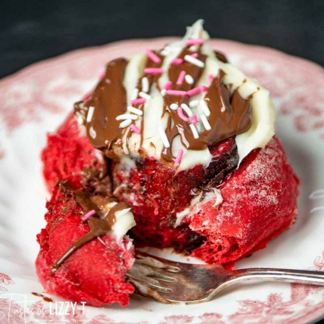 A close up of a piece of sweet roll on a plate, with Nutella and Cream