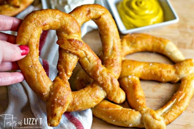 hand picking up a soft pretzel