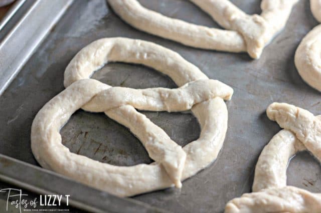 unbaked pretzels on a baking pan