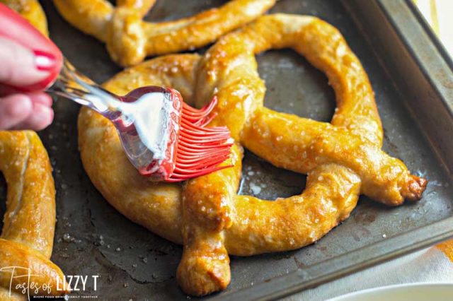 pastry brush brushing baked pretzels