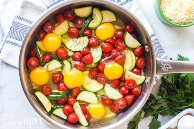 tomatoes, zucchini and eggs in a skillet unbaked