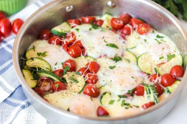 skillet with tomatoes, zucchini and eggs