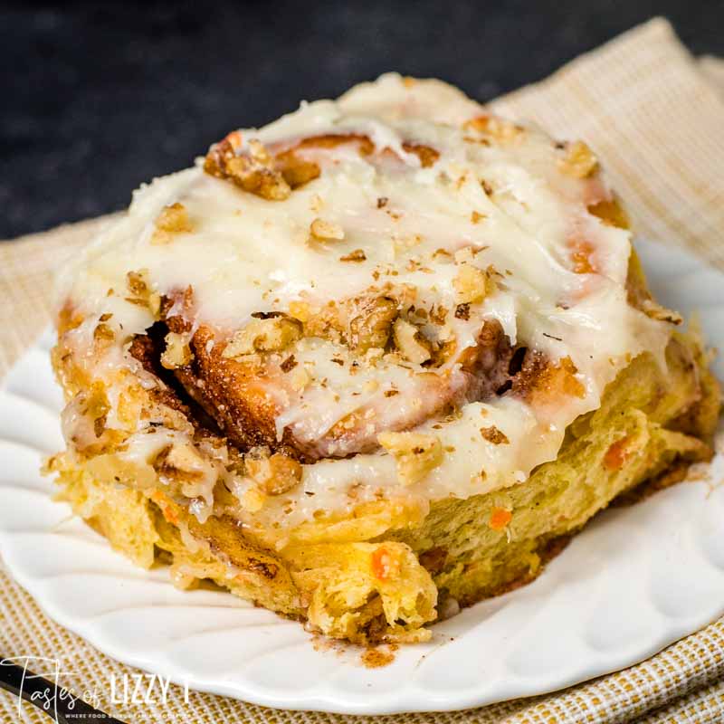 cream cheese frosted cinnamon roll on a plate