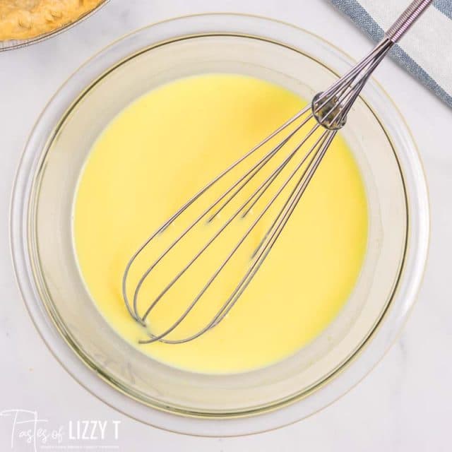 vanilla pudding in bowl with whisk