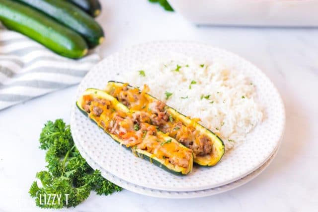 plate with rice and two zucchini boats