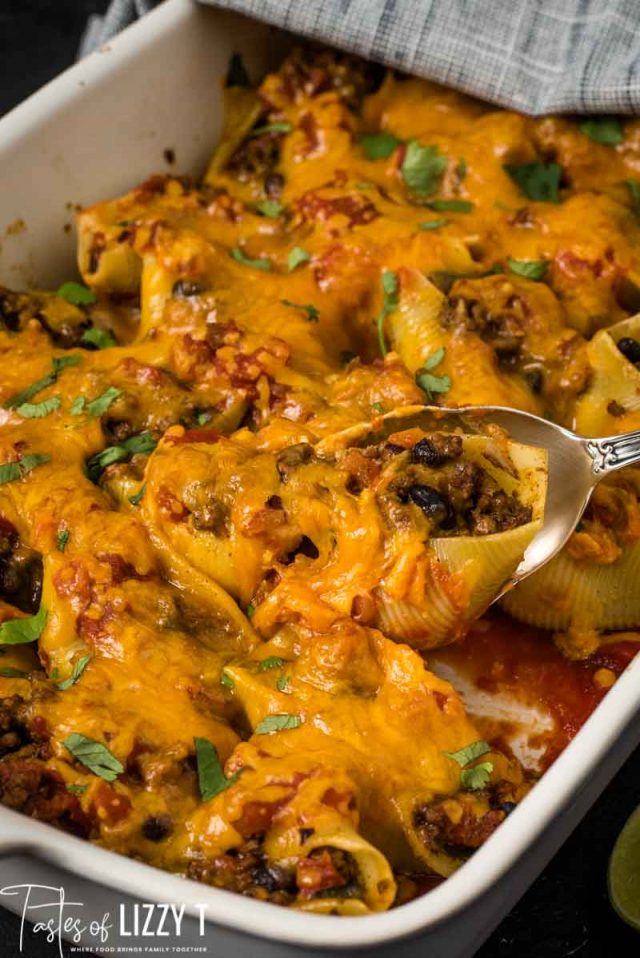 cheese topped taco stuffed shells in casserole