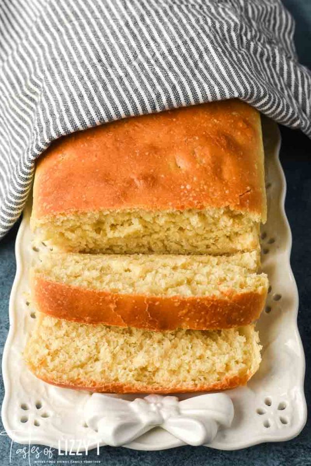 white friendship bread on a plate with two slices cut