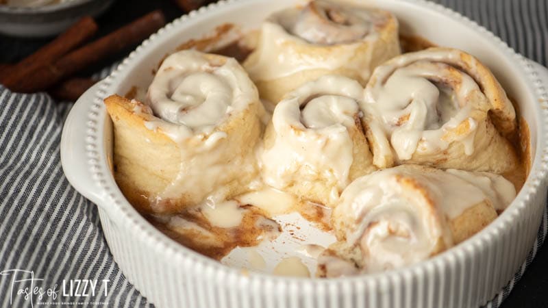 bisquick cinnamon rolls in a baking dish with glaze