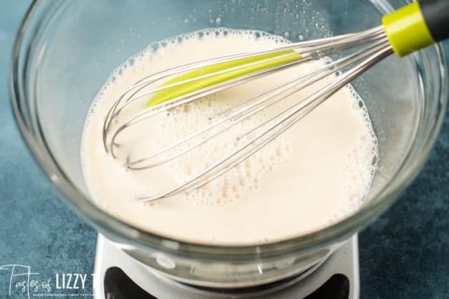 sourdough starter and water in a mixing bowl