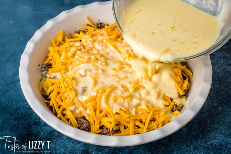 pouring egg mixture over beef and cheese