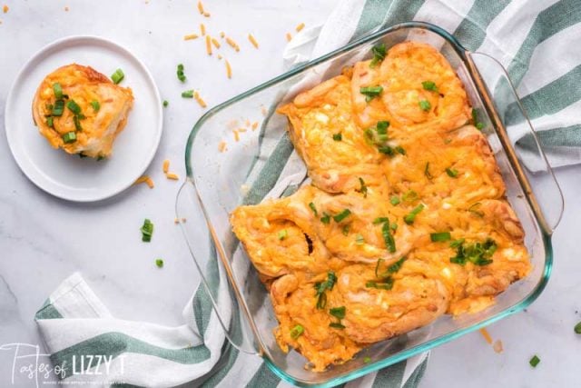 buffalo chicken pinwheels in pan with one plated