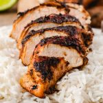 A plate of food, with jerk Chicken