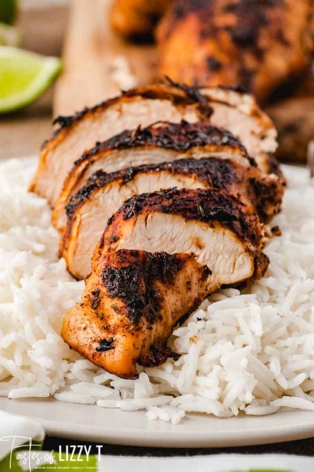 sliced chicken breast with seasonings over rice