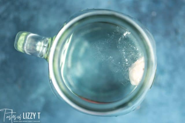 sourdough starter floating in a glass of water