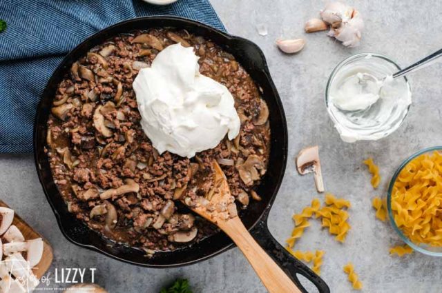 ground beef and mushrooms with sour cream in skillet