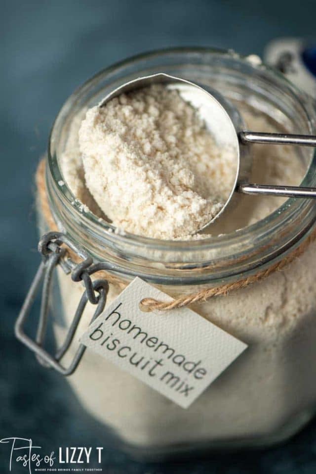 homemade biscuit mix in a glass jar with measuring scoop