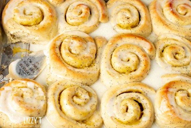 lemon poppy seed rolls in a pan with one missing