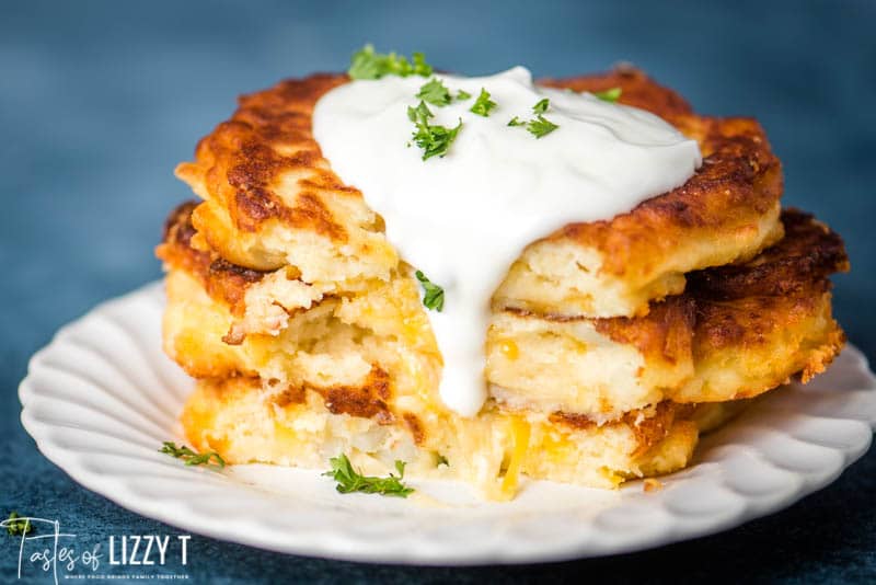 stack of potato cakes with sour cream dripping off