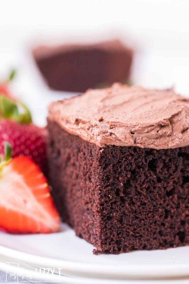 piece of chocolate cake with chocolate frosting and strawberry slices