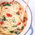 One Pot Pasta with tomatoes in a pot with a spoon