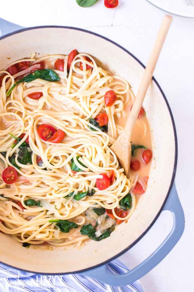 one pot pasta dinner in pot with wooden spoon