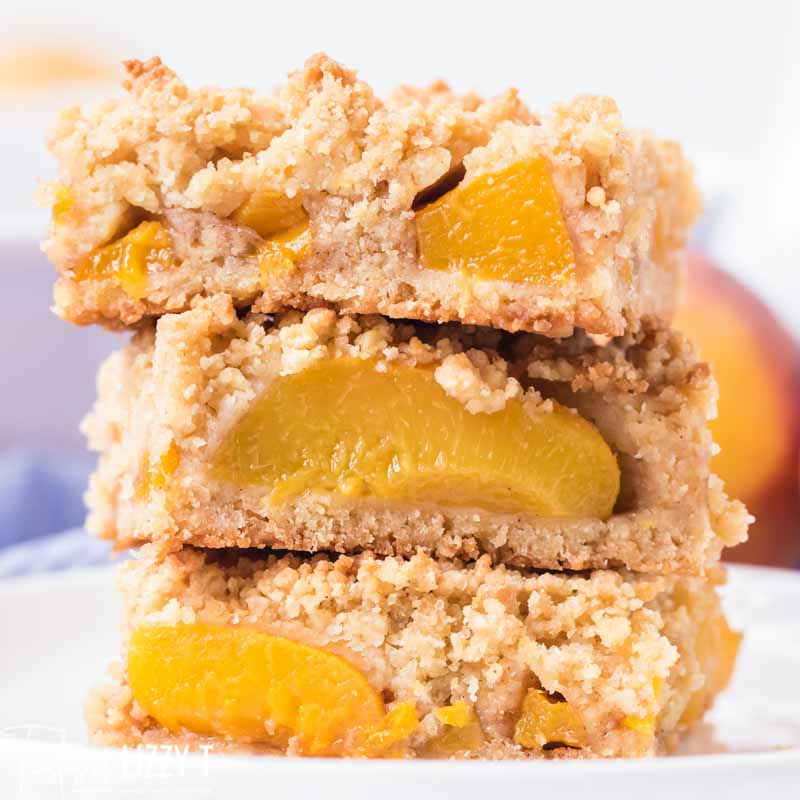 buttery peach crumb bars stacked on each other