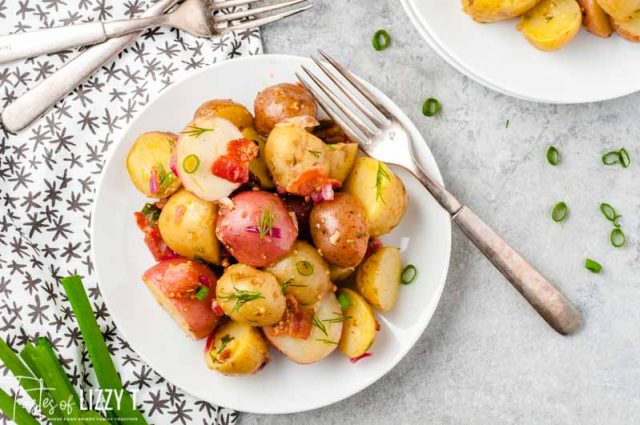 overhead shot of potatoes with bacon on a plate with forks