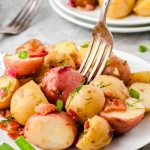 A plate of potatoes with a fork