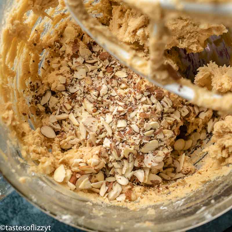 mixing bowl with cookie batter and almonds