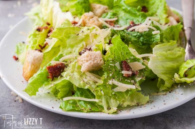 plate of lettuce with croutons, bacon and cheese