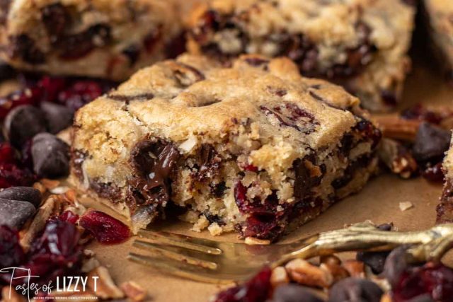 chocolate chunk cranberry coconut blondies with a bite out of it