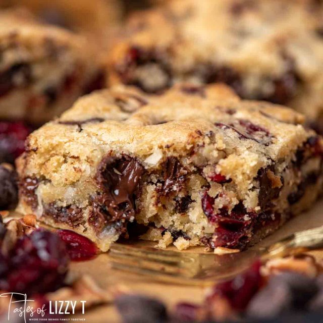 Loaded Cranberry Coconut Blondies with a bite out of it