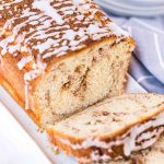 loaf of cinnamon roll quick bread with two slices cut