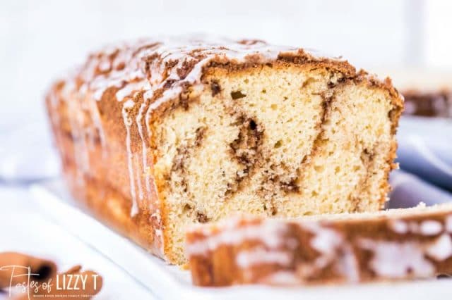 loaf of cinnamon roll quick bread with one piece cut