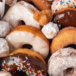 box of homemade donuts with donut holes on top