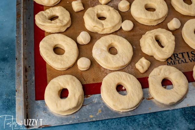 unbaked donuts on a baking sheet