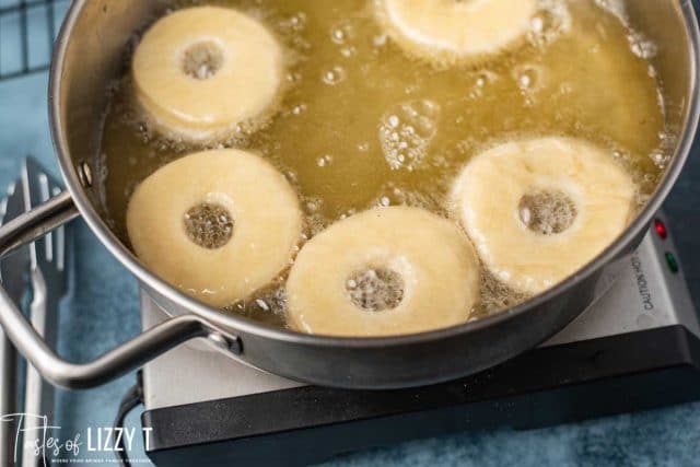 donuts frying in a skillet