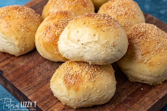 pile of homemade hamburger buns on a cutting board