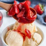 strawberry sauce pouring over ice cream