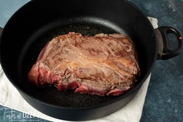 beef chuck roast seared in a pan