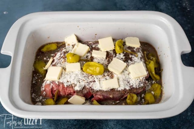 uncooked misississippi pot roast in a slow cooker