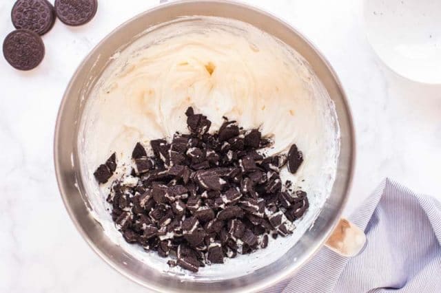 chopped oreos in cheesecake batter