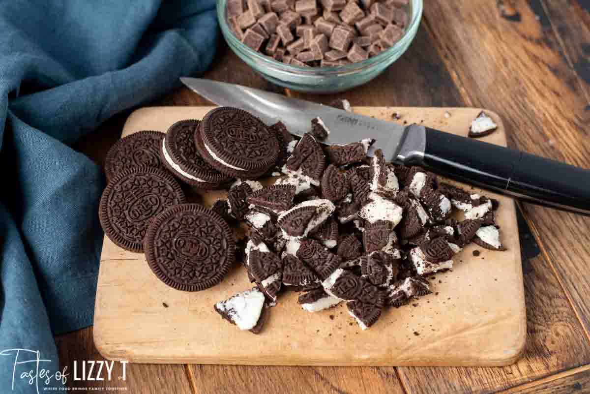 5 whole oreos and 4 chopped oreos on a cutting board