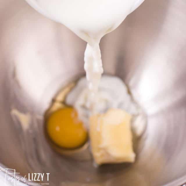 milk pouring into mixing bowl