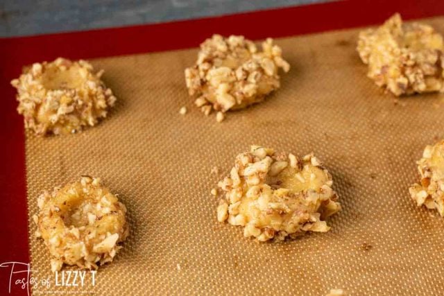 unfilled thumbprint cookies on baking mat