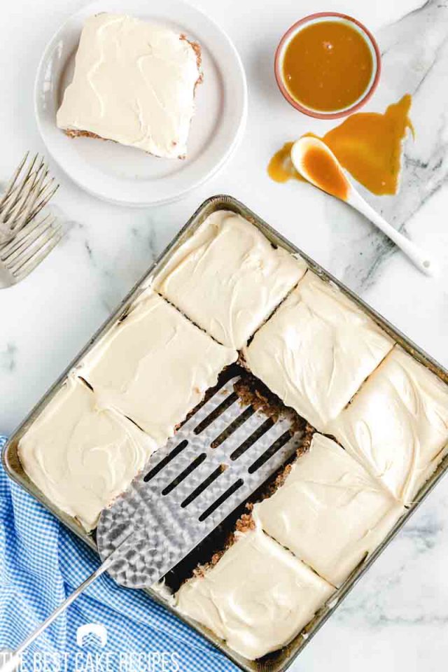 overhead shot of frosted crazy spice cake with two slices removed