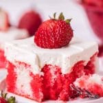 pice of strawberry jello cake on a plate with a bite out of it
