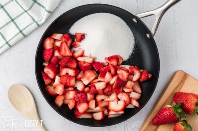 strawberries and sugar in a skillet
