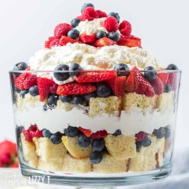 glass trifle bowl with fresh berries and cake
